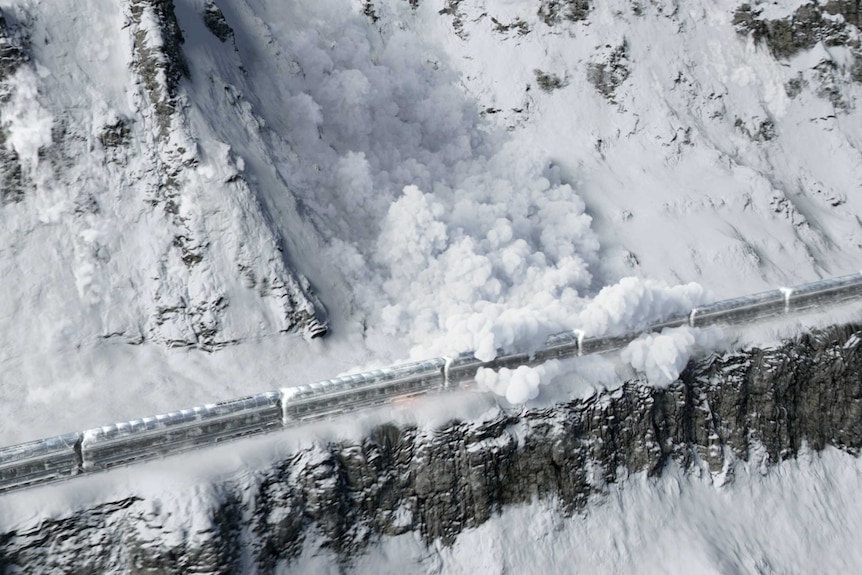 A promotional poster shows a train running through a destructed city in the snow