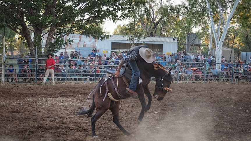 A horse tries to throw its rider at the Fitzroy Crossing Rodeo.