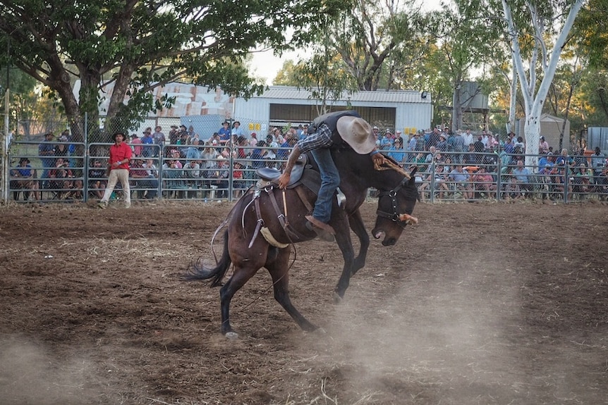 A horse tries to throw its rider at the Fitzroy Crossing Rodeo.