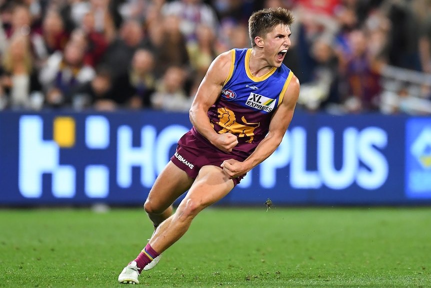 A Brisbane Lions AFL player pumps his fists after kicking a goal against the Western Bulldogs.