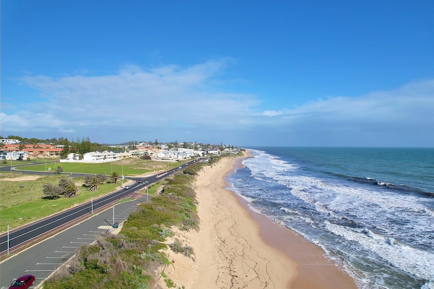 A shot showing the beach and some buildings.