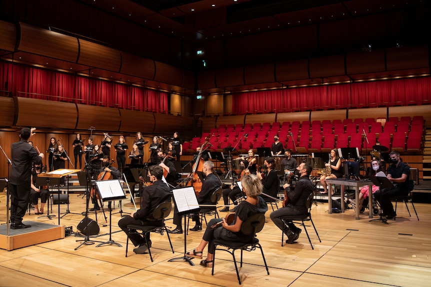 Alexandra Kerlidou sits in the orchestra playing the "eyeharp"