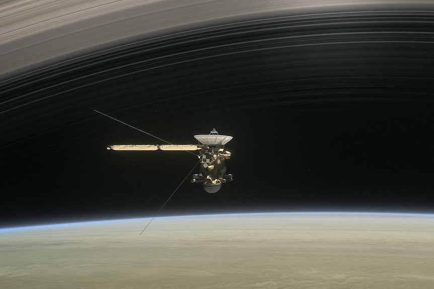 Artist's concept of Cassini diving between Saturn and its rings