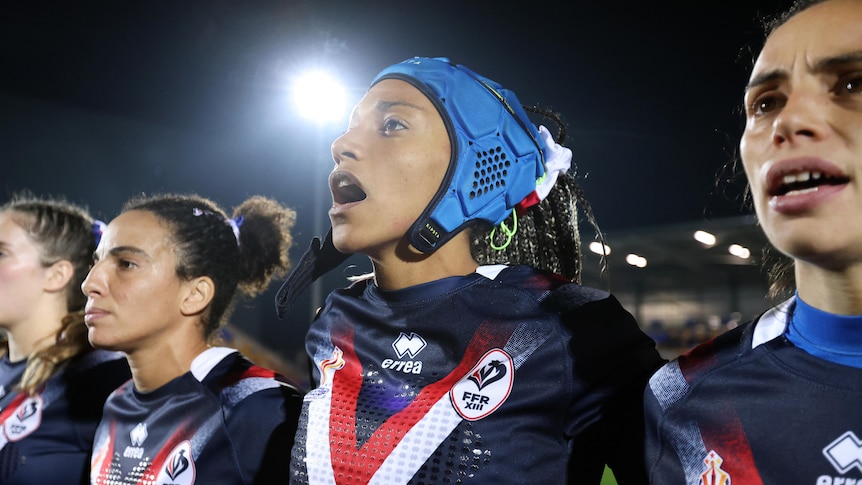 Elisa Akpa sings the French national anthem before a Women's Rugby League World Cup game against Australia.