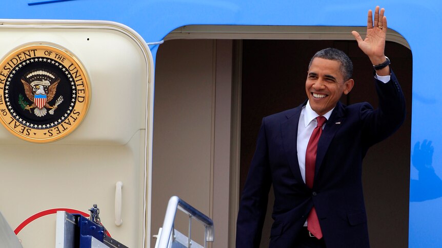Barack Obama waves upon arriving in Canberra