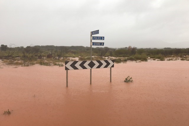 A street sign protrudes from floodwaters in Kintore, Central Australia