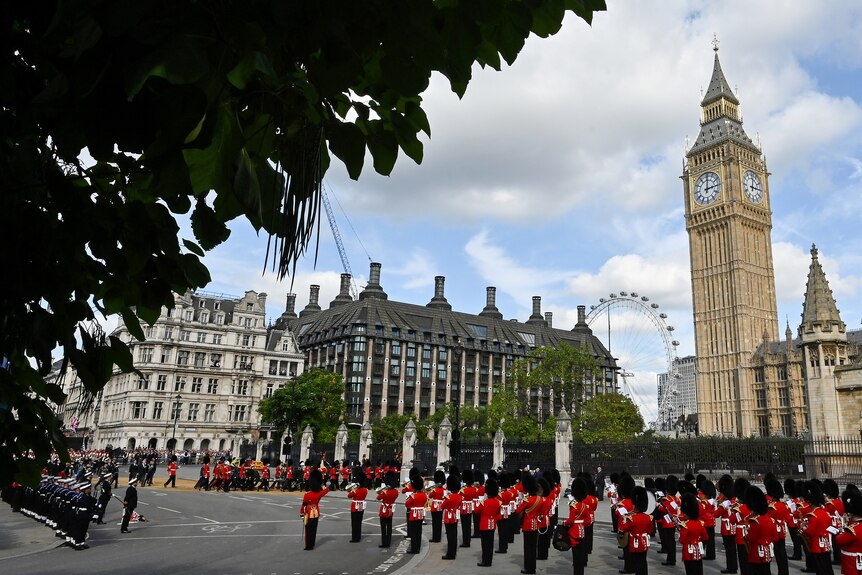 Guards stand at attention in front of Westminster.