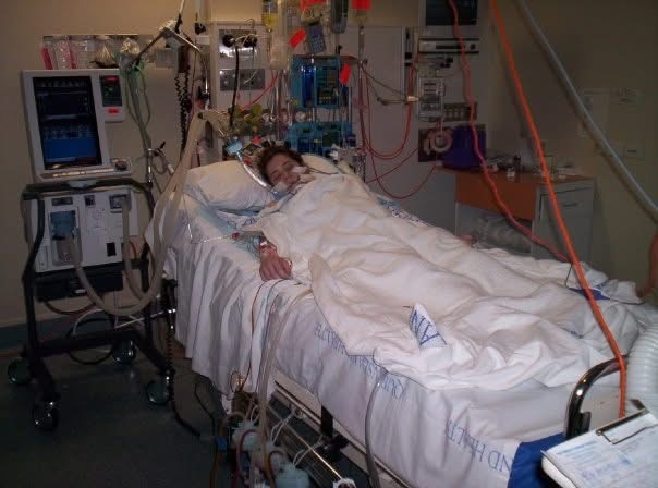 A girl lying in a hospital bed following a transplant