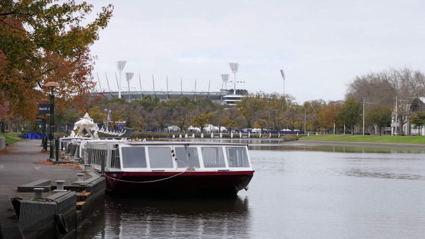 A Yarra river cruise boat sits in front of the MCG.