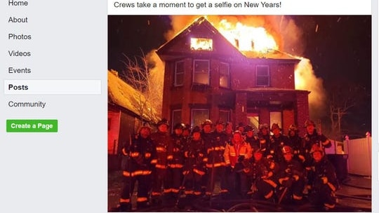 The Detroit Fire Incidents Page showing a photo of 18 firefighters standing in front of a burning house.