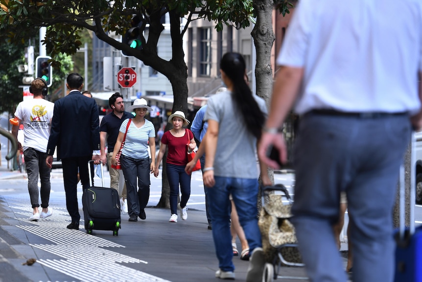 People walk down a Sydney street.