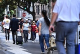 People walk down a Sydney street.