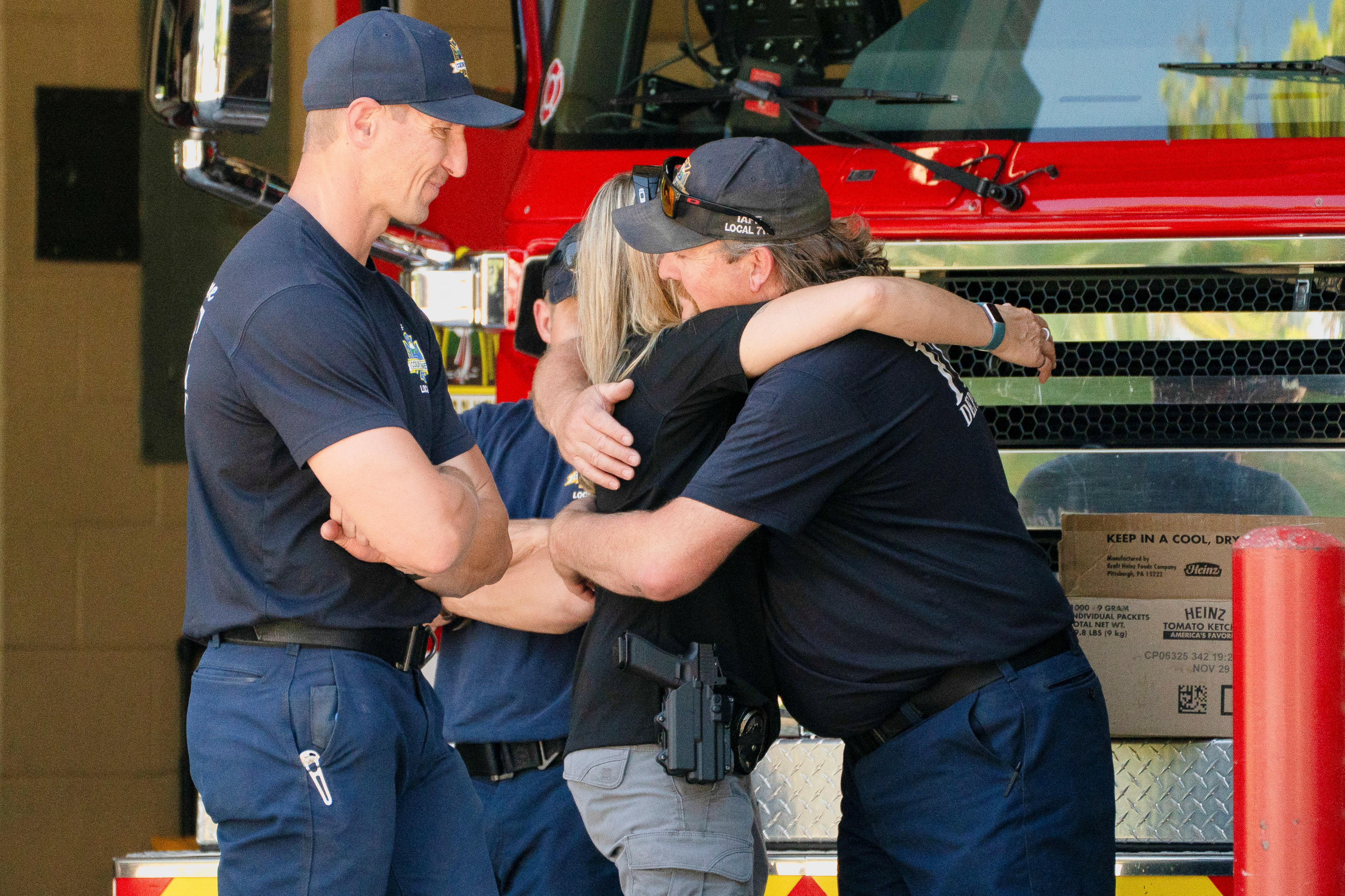 People cuddle for a fire truck