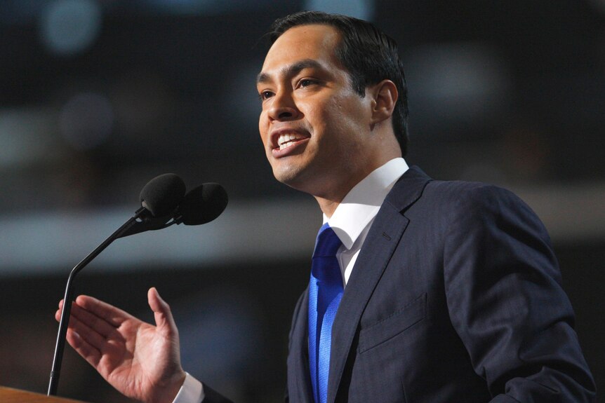 Julian Castro speaks into a microphone while gesturing with his hand.