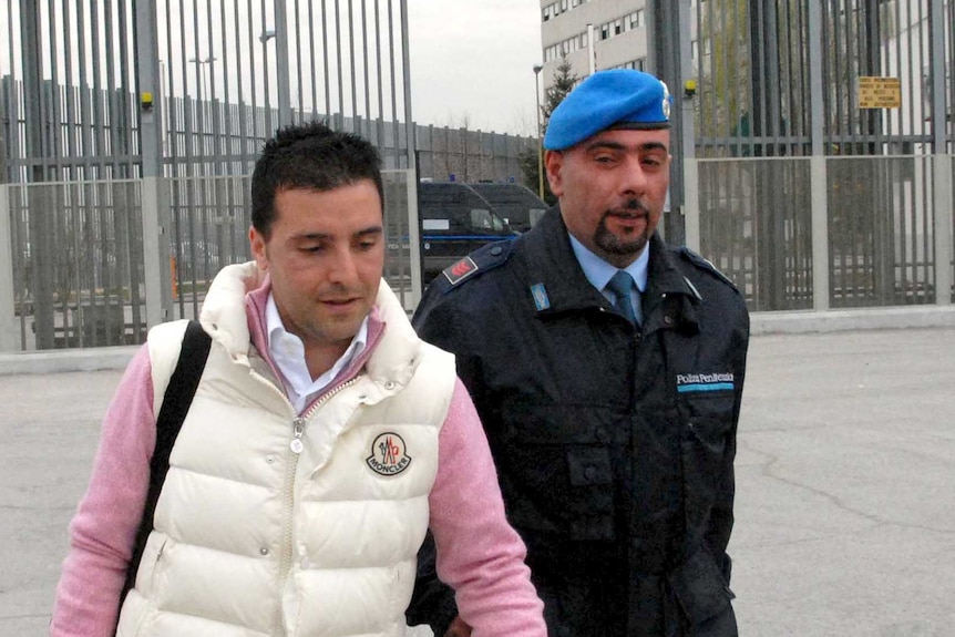 Giuseppe Salvatore Riina walks out of a prison.