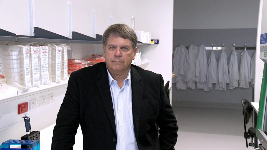 Professor Alan Trounson poses for a photo in a laboratory.