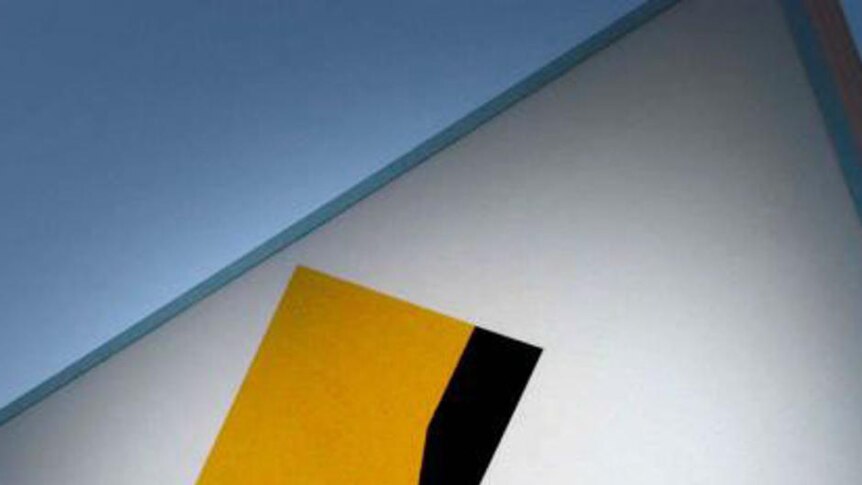 A Commonwealth Bank sign against a blue sky.