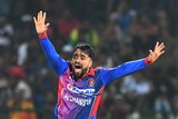 Rashid Khan appeals with his arms up and outstretched