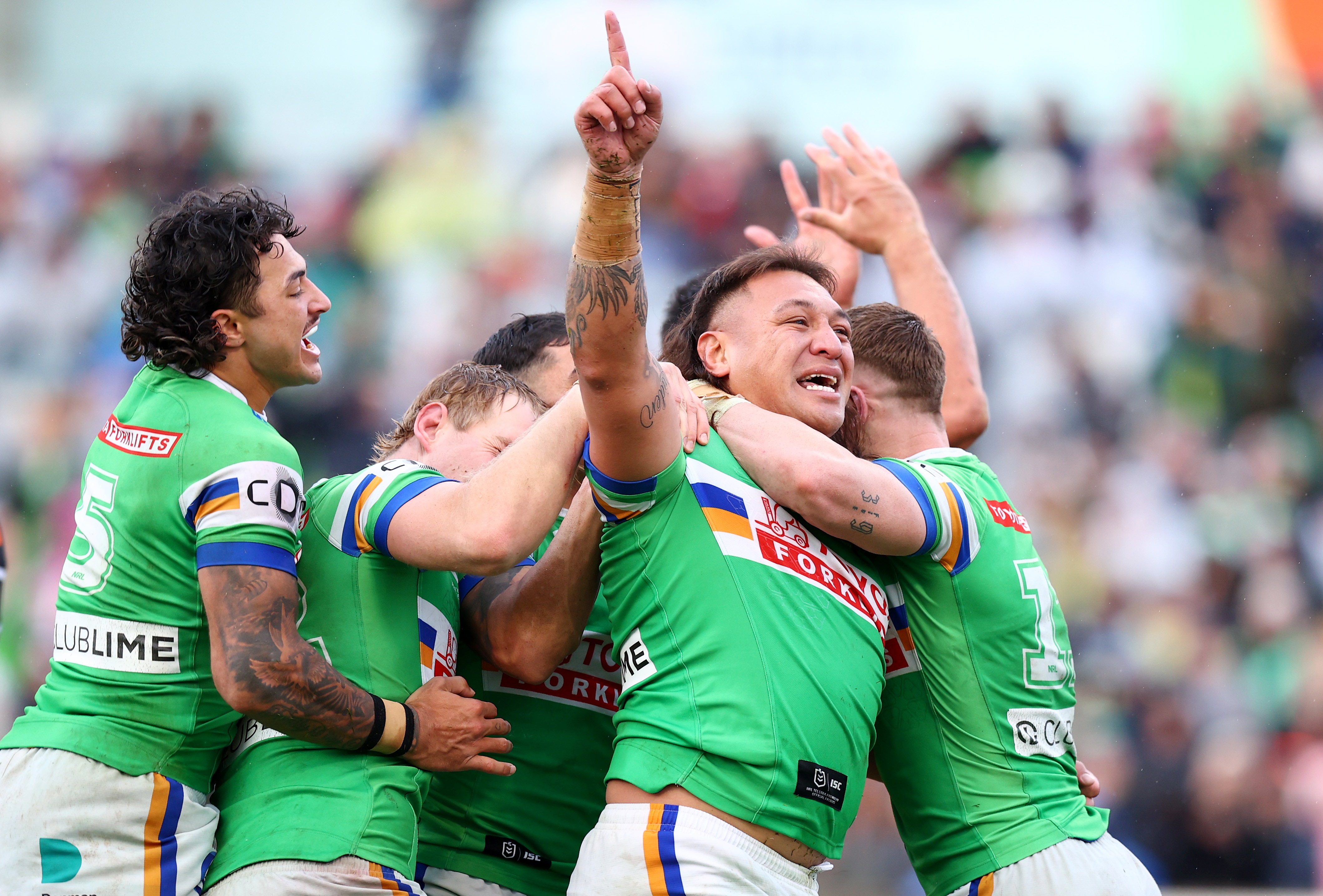 A man celebrates a try in an NRL match.