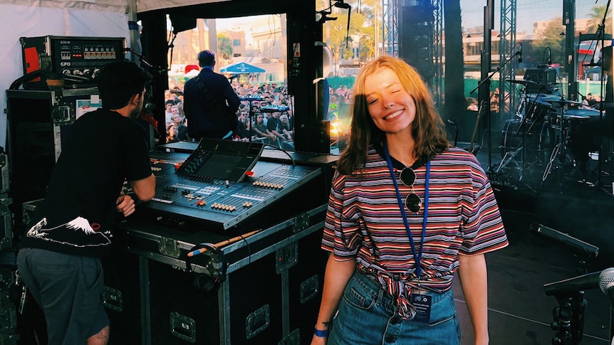 triple j Good Nights presenter Bridget Hustwaite side-of-stage at St Kilda Festival 2019