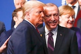 NATO secretary general Jens Stoltengberg is pictured putting his hand on the back of President Trump at a NATO leaders meeting.