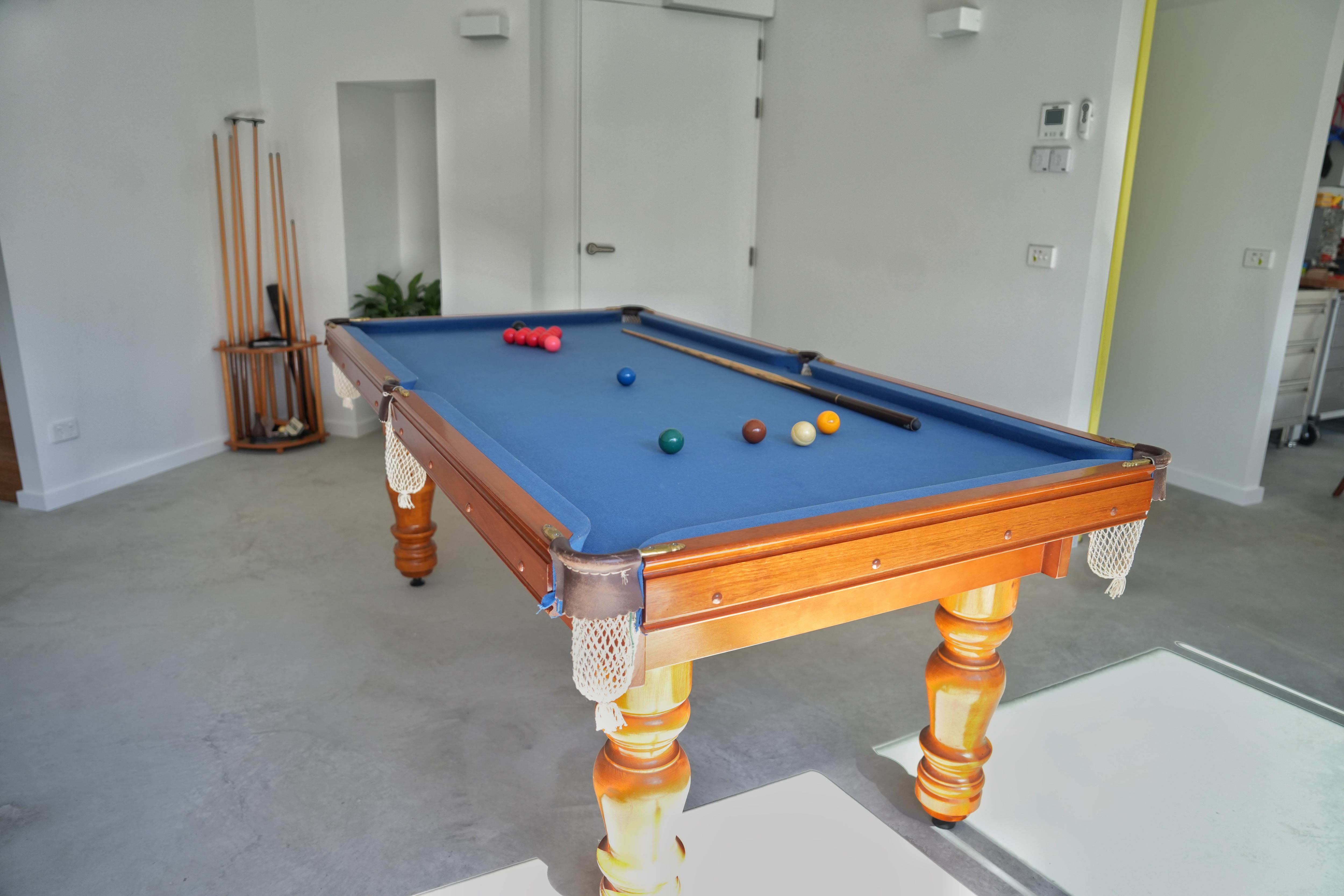A pool table in a room in a house.