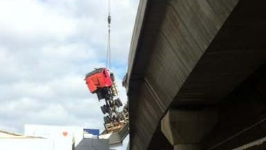 Crashed truck being lifted onto road in Melbourne