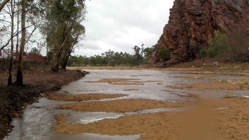 Stormwater runoff trickles down the Todd River in Alice Springs
