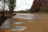 Stormwater runoff trickles down the Todd River in Alice Springs