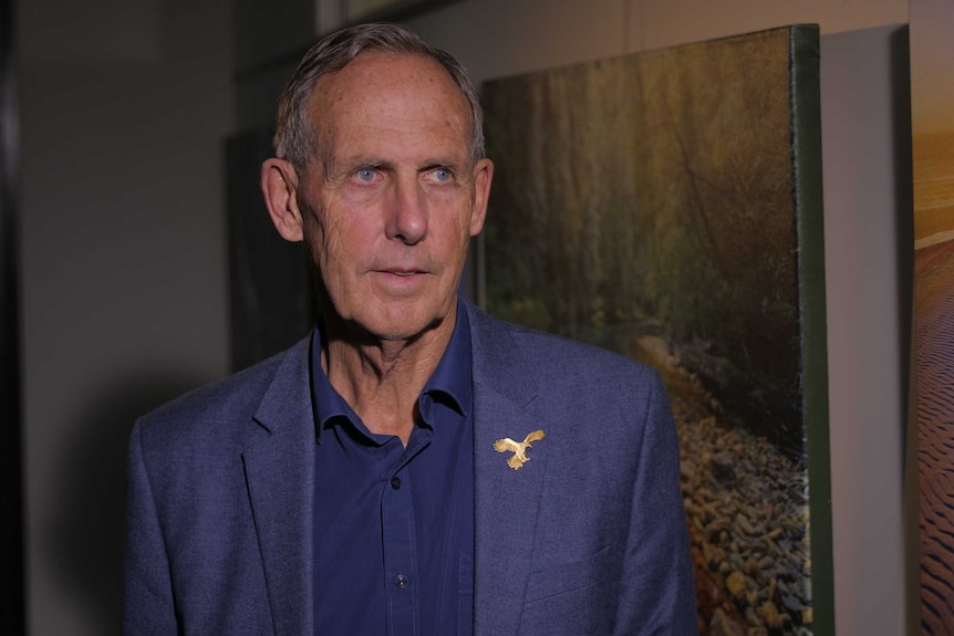 Bob Brown wears a blur shirt and blue suit jacket.