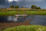 two men in a boat on a lake.