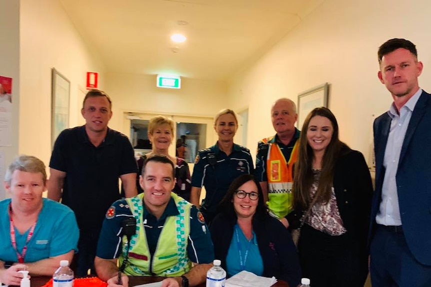 Queensland's Health Minister Steven Miles and Transport Minister Mark Bailey at the retirement village with staff.