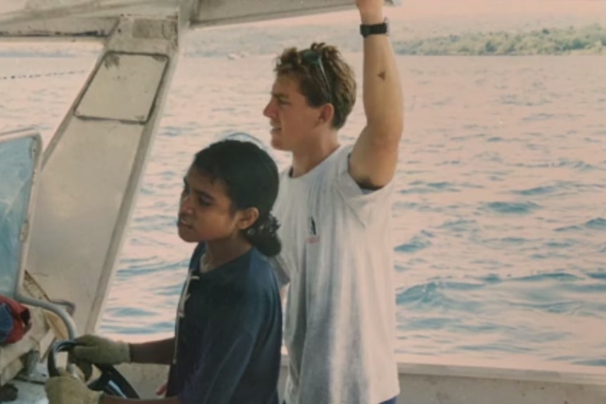 Photo of Damien Bell on a boat with a fellow Indonesian pearl farmer