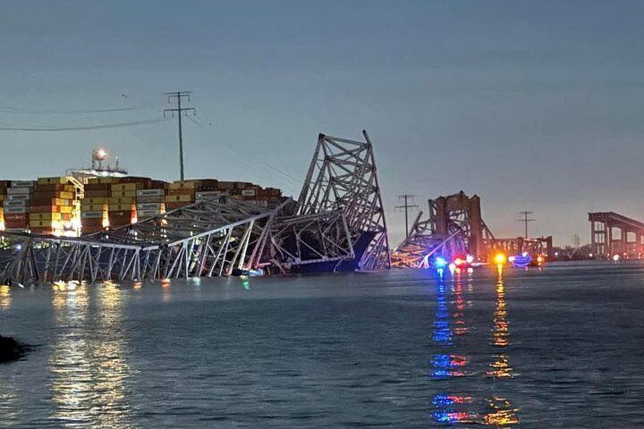 A body of water with collapsed bridge in the background.