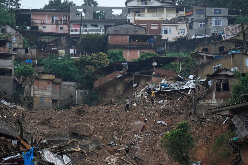 Residents look for victims in an area affected by landslides in Petropolis.