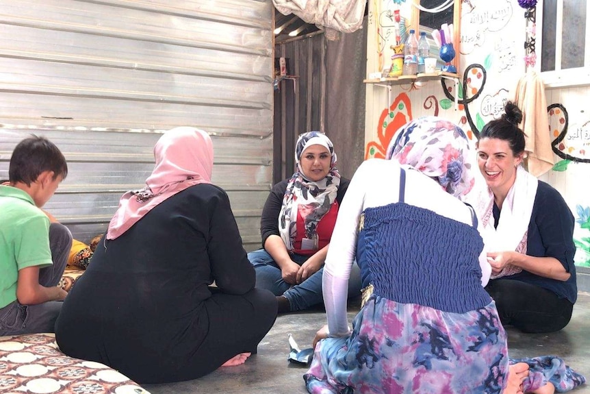 Ashlynne McGhee interviewing refugees at the Zaatari refugee camp.