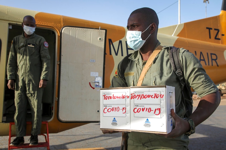 A soldier holds samples from potential COVID-19 patients.