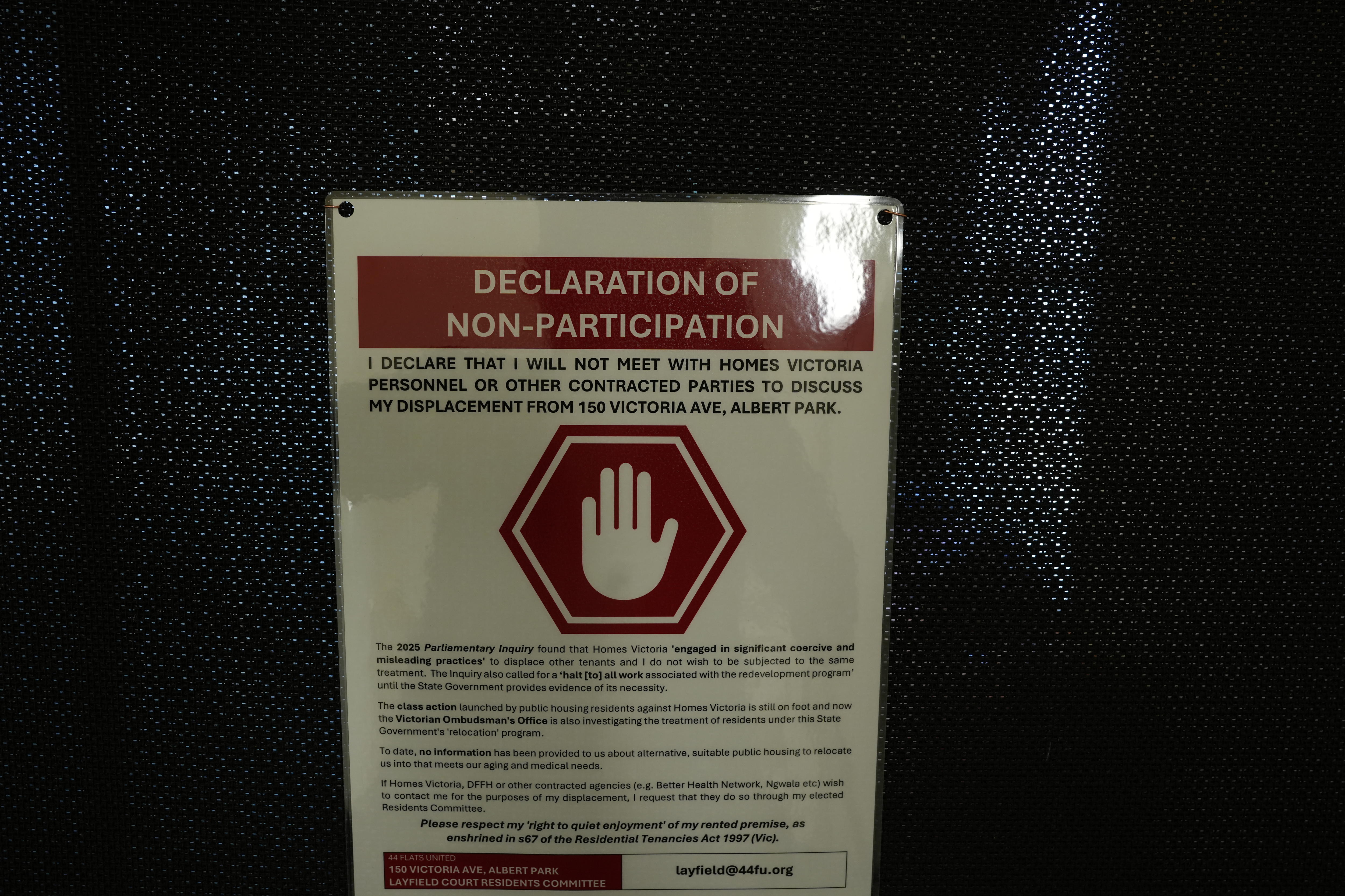 White sign warning residents not to speak to Housing Victoria in building 