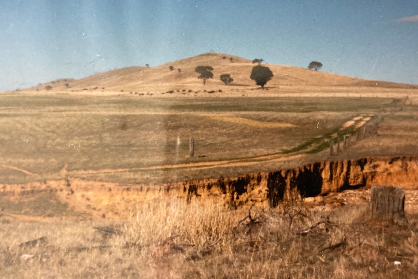 a red eroded gully in the foreground 