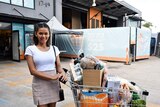 Mia Lam poses with groceries outside Lighthouse Care in Logan.