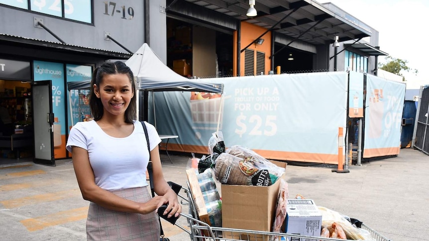 Mia Lam poses with groceries outside Lighthouse Care in Logan.