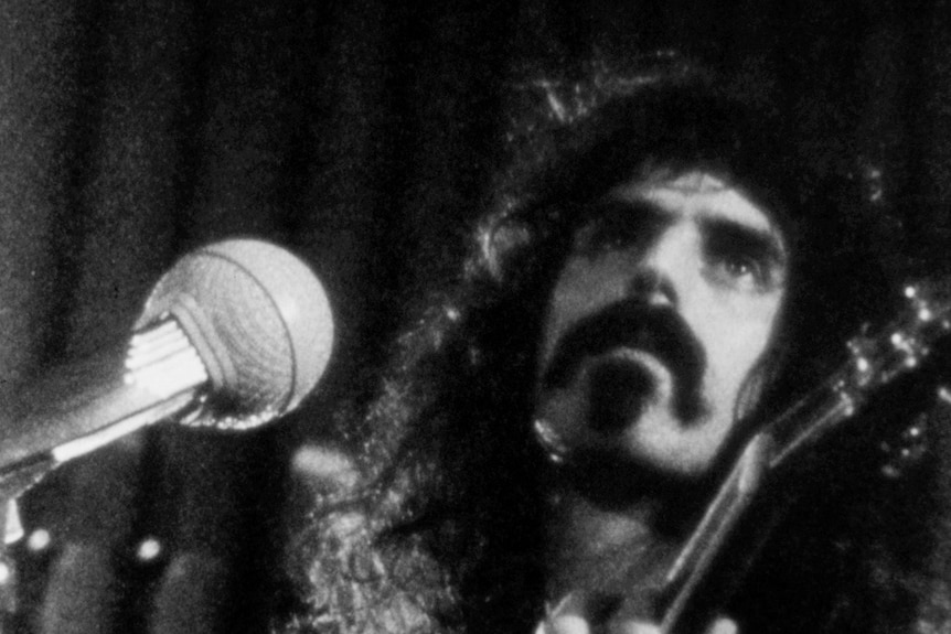 A black and white photo of Frank Zappa.