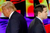 Donald Trump and Marco Rubio appear to be back to back as they walk past each other.