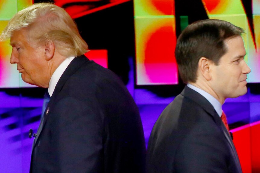Donald Trump and Marco Rubio appear to be back to back as they walk past each other.