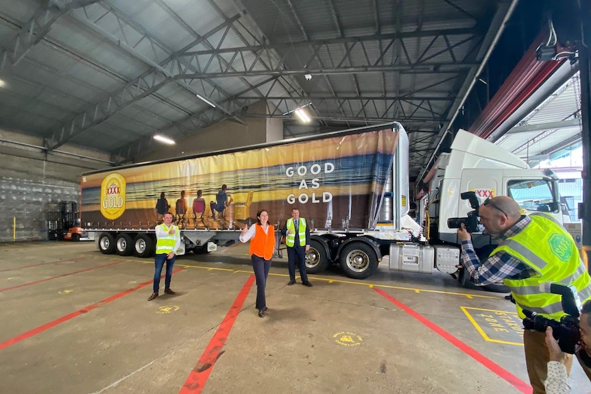 Queensland Premier Annastacia Palaszczuk stands beside a truck containing free beer that will be driven to outback communities.