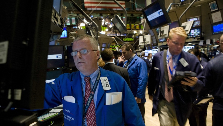 Traders work on the floor of the New York Stock Exchange in New York on September 15, 2008