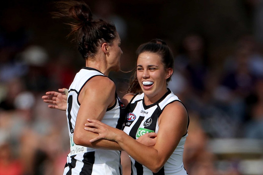 Sharni Layton and Chloe Molloy celebrate a Collingwood goal in the AFLW.