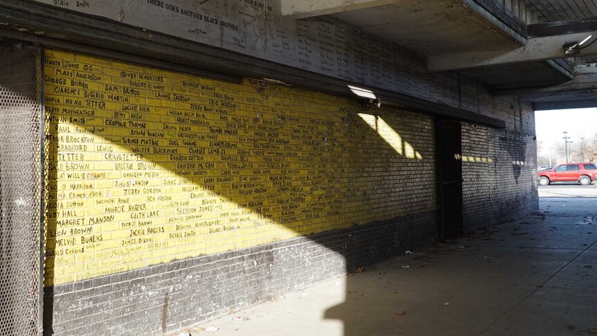A wall in Altgeld Gardens bears the names of residents who have died