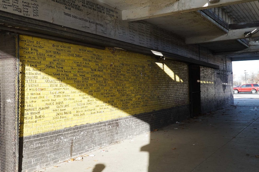 A wall in Altgeld Gardens bears the names of residents who have died