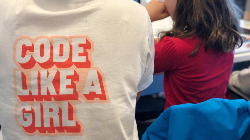 An instructor helps a girl at a Code Like A Girl workshop in Sydney